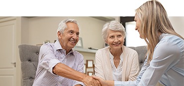 elderly couple speaking with healthcare navigator