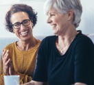 two woman laughing together