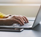 woman typing on a laptop