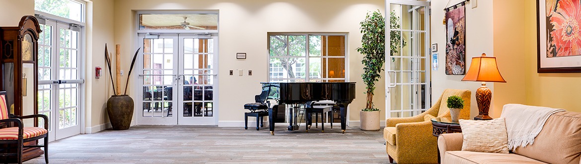 lounge area with couches and a piano