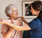 skilled nurse assisting resident with stretching