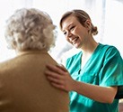 nurse with her arm on a residents back