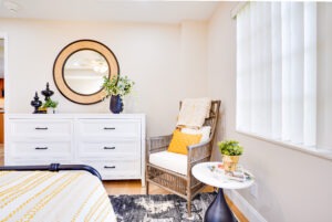 bedroom with whickered chair in the corner