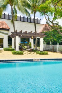 pergola with seating next to the pool