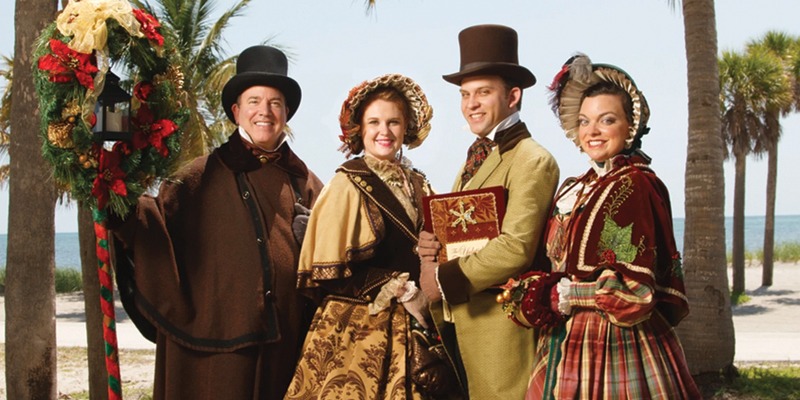 the yuletide carolers standing in front of a beach